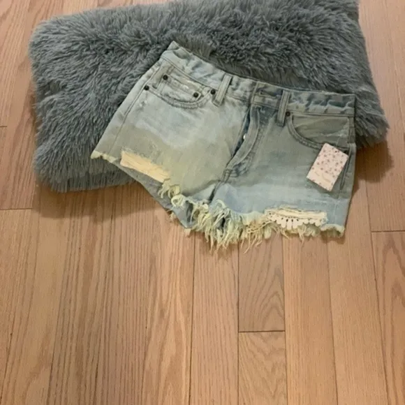 Free people light distressed denim shorts