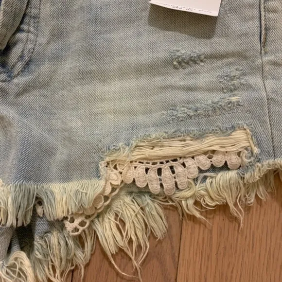 Free people light distressed denim shorts