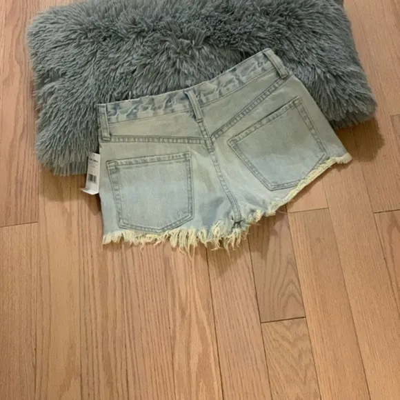 Free people light distressed denim shorts