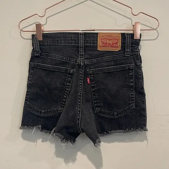 Levi’s black 501 Buttonfly denim high rise cut off shorts.  Size 24